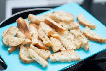 Wall Mural - A blue cutting board with bread slices on it