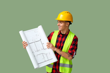 Poster - Young male engineer with blueprint on green background