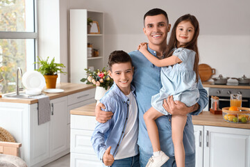 Wall Mural - Little children with their father hugging at home