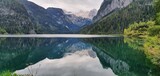 Fototapeta Do pokoju - Reflecting mountains in a mountain lake in Austria. Gosausee Austria 2022