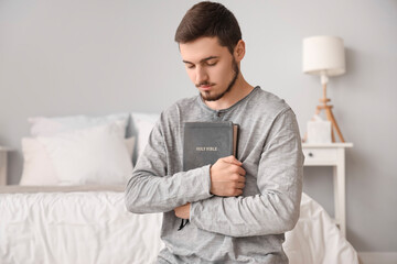 Sticker - Young man with Bible praying in bedroom