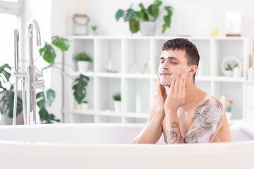 Sticker - Handsome man taking bath with foam at home