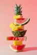 A colorful stack of fresh sliced juicy fruits on pink pastel background. Minimal food still life concept.	