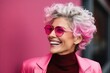 Closeup portrait of a beautiful woman with pink hair wearing pink sunglasses