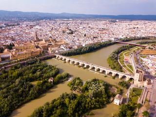 Wall Mural - Aerial view of Historic centre of Cordoba with antique Roman Bridge over Guadalquivir river and medieval Mosque-Cathedral, Spain