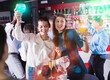 © JackF - Two smiling girls drinking cocktails and dancing on corporate party