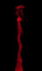 Canvas Print - Abstract background of chaotically mixing puffs of red smoke on a dark background