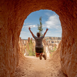 Fototapeta Sawanna - Woman Jumps In Tunnel In Bryce Canyon