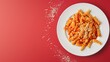A vibrant dish of fusilli pasta topped with tomato sauce and grated cheese, presented on a white plate against a red background