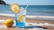 Cold drink with ice and a slice of lemon on the beach on a hot summer day