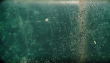 Artistic Vintage Photo With Film Grain, Dust And Scratches. Dark Green Rusty Metal Plate For Background Textures. Old-fashioned; Shallow Depth Of Field