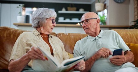 Poster - Senior couple, sofa and relax with conversation, book or phone in retirement together at home. Elderly man and woman talking, chatting or discussion on lounge couch with novel and mobile smartphone