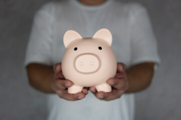 Business finance and saving money investment concept. Man holding pink piggy bank. Save money for future