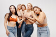© Maria Vitkovska - Modern diverse, multiracial group of women wearing sexy bras and jeans hugging, looking at camera