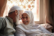 An elderly oriental man and woman sit together in front of a window, showcasing love and companionship