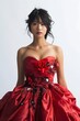 Portrait of a pretty young woman super model of Japanese ethnicity donning an elegant red ball gown with a fitted bodice, voluminous skirt, and delicate floral