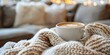 © Bussakon - Cozy Blanket and Aromatic Coffee on a Comfortable Sofa - A Serene Moment of Relaxation and Contentment in a Warm,Inviting Home Setting
