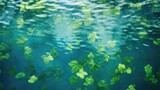 Fototapeta Do akwarium - Green leaves on the surface of the water. Beautiful background with water ripples for product presentation. Summer refreshing background.
