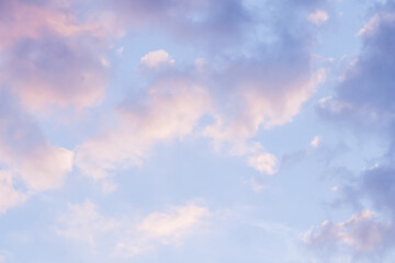 Wall Mural - Blue sky background with pale pink clouds at sunset