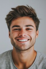 Canvas Print - A young man smiling and looking at the camera. Suitable for various projects