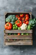 A wooden crate filled with a variety of fresh vegetables. Perfect for food and agriculture concepts
