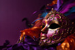  Mardi gras mask, vibrant and rich colors, top angle, right copyspace, purple background
