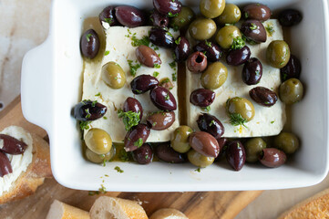 Wall Mural - Feta salad with black and green olives. Marinated with olive oil and herbs. 