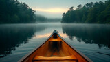 Fototapeta  - Canoe bow on a misty lake with forest backdrop, serene and tranquil morning.