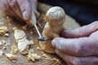 hands carving a wooden figurine with a gouge