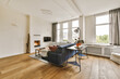 © ADDICTIVE STOCK - Modern living room with hardwood floors and natural light