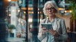 © VISUAL BACKGROUND - Business woman looks down while holding tablet