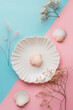 Abstract seashell background template for placement product on it. Modern, minimal, studio setup, complementary colours, flat lay.