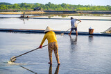 Fototapeta Londyn - Farmers working on salt fields in Can Gio district of Ho Chi Minh City, Vietnam.