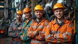 © Georgii - Confident industrial workers with safety helmets in a factory