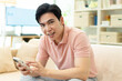 © Timeimage - Photo of young Asian man at home