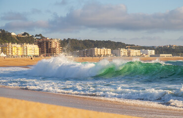 Wall Mural - Big wave in Atlantic Ocean on the beach in Nazaré, Portugal