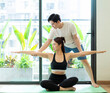 Photo of young Asian couple do exercise together at home