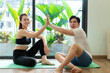 Photo of young Asian couple do exercise together at home