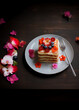 Delicious pancakes with honey, blueberry and edible flowers. Healthy breakfast concept with copy space