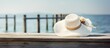 A close-up view of a hat placed on a wooden dock next to the water