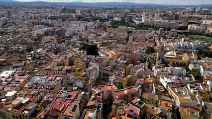 Wall Mural - Cinematic aerial view of old town center of Valencia. View of Cathedral of Valencia and Plaza de la Reina. Drone circling above the city center. Famous travel destination. Medieval historic city.