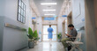 Hospital Corridor with Active Doctors and Nurses Working and Patients and Visitors Waiting. Modern Indian Clinic Providing Different Healthcare Services