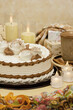 Dessert in the form of a cake in a festive setting. Poster for interior. Large cake with a mug of tea on a background of candles.