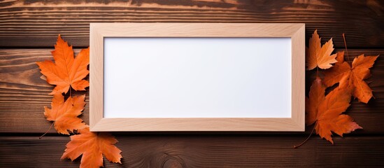 Poster - An arrangement of autumn leaves is placed within a wooden frame on a wooden surface