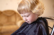 happy little girl shows off her trendy new haircut at the beauty salon.