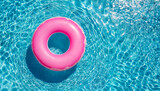 Fototapeta Sypialnia - Pink inflatable ring floating in swimming pool water, summer holiday concept