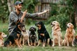 A professional dog trainer is instructing a variety of different dogs who are sitting attentively in a row