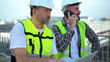 team of Construction workers Senior architect or civil engineer and foreman walking and discussion to inspection or checking structure apartment with tablet computer at construction site. building