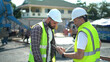 team of Construction workers Senior architect or civil engineer and foreman control labor workers pouring concrete on floors and discussion to inspection or checking with tablet at construction site.