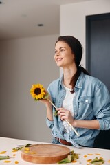 Wall Mural - Smiling Woman Holding a Bouquet of Blooming Flowers in a Green and White Garden